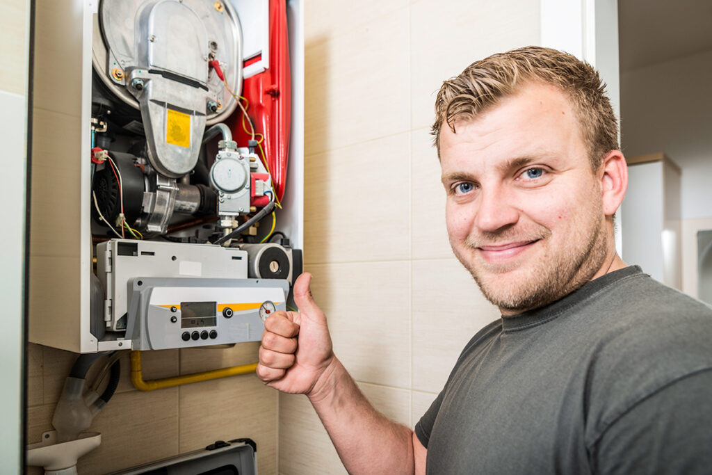 An HVAC technician giving a thumbs up