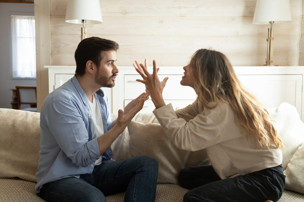 A man and a woman arguing in a bedroom