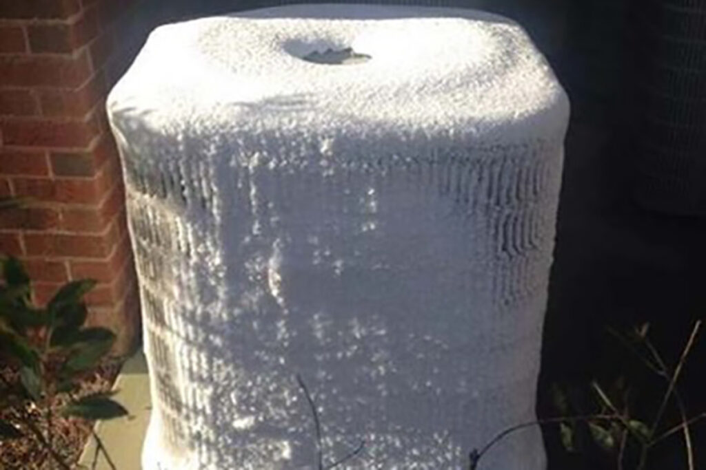 An outdoor A/C unit completely coated in ice