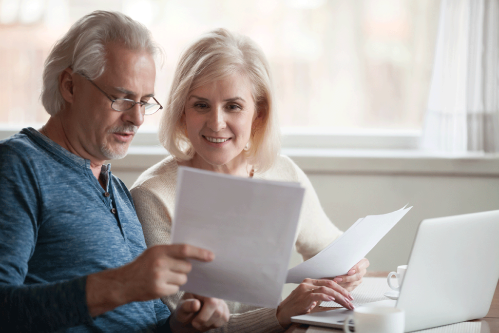 Older couple happily reviewing documents