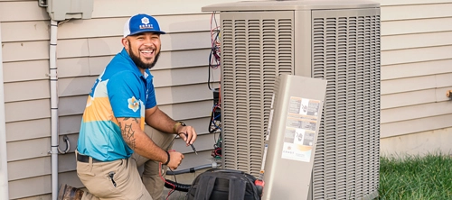Ernst technician working on an air conditioner