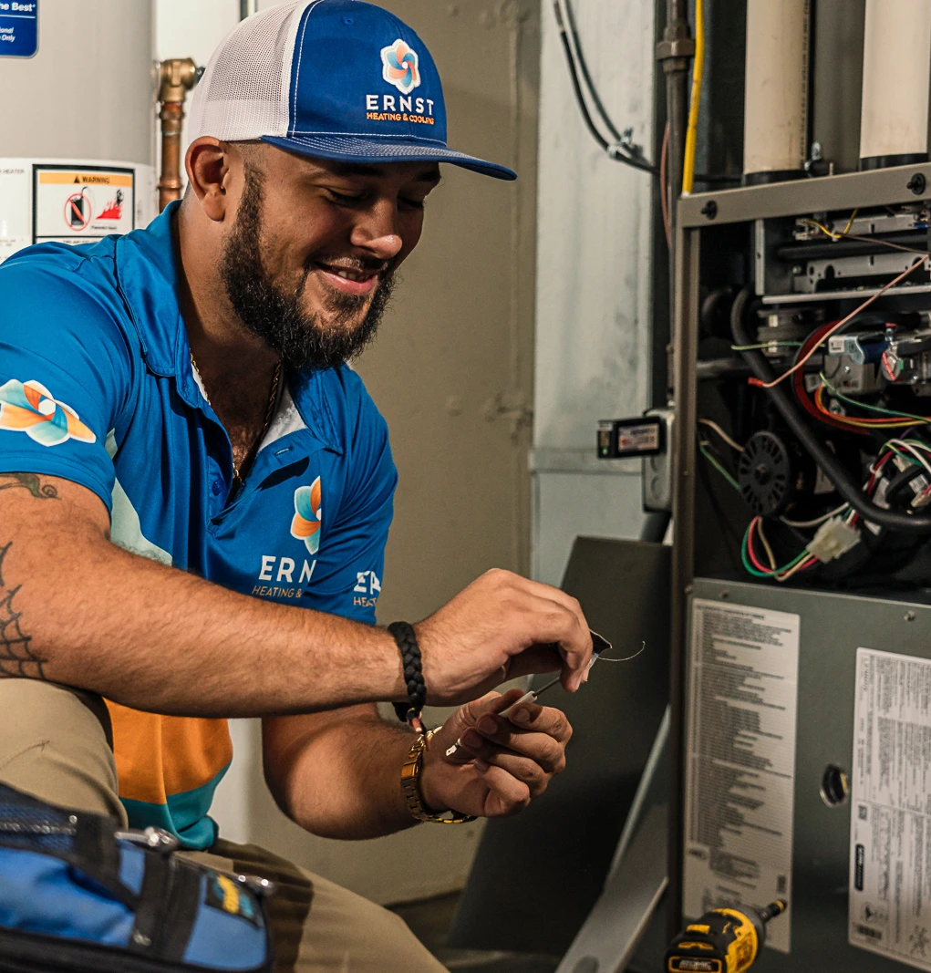 an Ernst technician cleans a furnace flame sensor