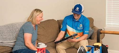 an Ernst technician chats happily with a customer about their geothermal heat pump system